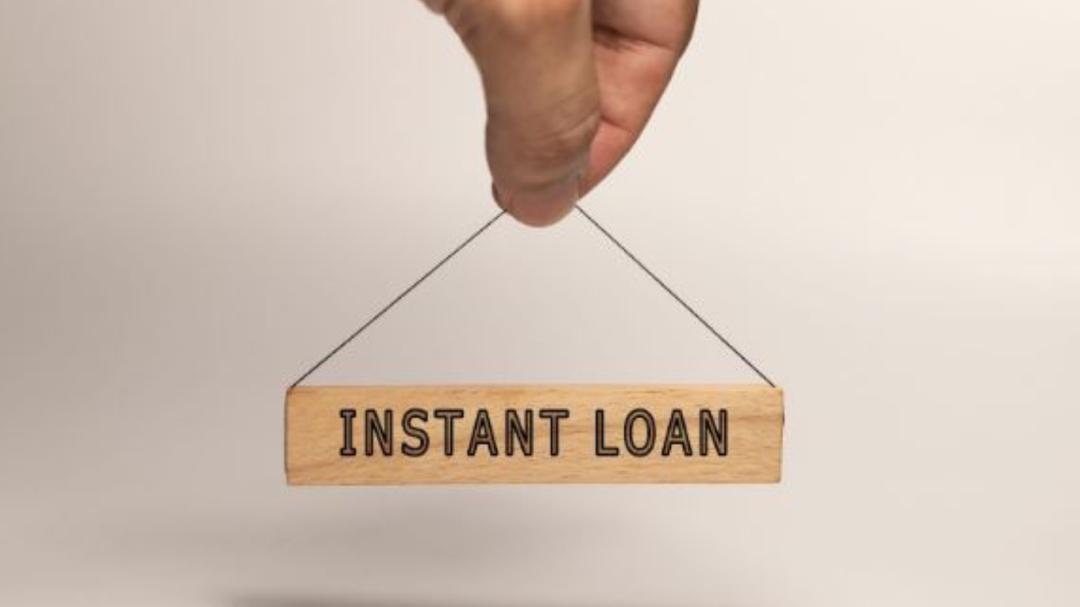 Young freelancer working on laptop after instant loan approval